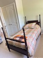 Full view of assembled twin four-poster bed with bedding