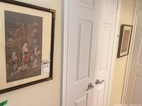 First framed print hanging on wall showing bamboo-style frame and mat