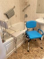 Transfer bench and shower chair positioned beside bathtub