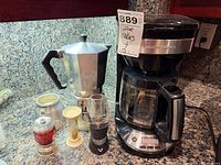 Group shot showing coffee maker, moka pot, wine aerator, hourglass, decorative shakers
