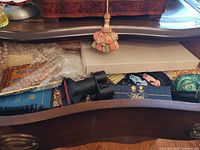 Drawer view showing dustpan, brush, vacuum attachments, bubble-wrapped icon, Floris bottle box, seasonal wood pieces