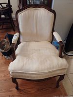 Front view of armchair showing frame, upholstery and overall wear