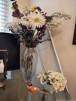 Vase with mixed artificial flowers, porcelain bird figurine, ceramic planter with white flowers