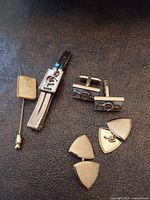Overview of tie clip, cufflinks, triangular shirt studs and hospital stick pin