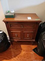 Front view showing drawer, cabinet doors, legs