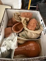 Box overview showing multiple terracotta pieces and glazed element