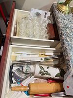 Drawer showing jars, utensils, and rolling pins
