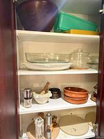 Cabinet view of kitchenware assortment on shelves