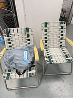 Front view of both folding chairs with AeroBed bag on seat