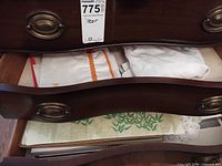 Open drawer showing mixed linens and placemats
