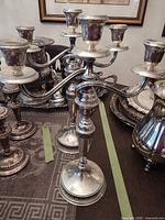 Pair of five-arm silver candelabra on table
