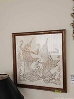Framed Thai temple rubbing print on wall showing full piece