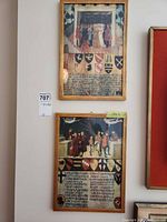 Two framed heraldic prints on wall