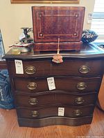 Front view of four-drawer serpentine chest