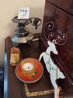 Group view: silverplate compote, decoupage dish with votive, ceramic clog, wood reindeer