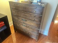 Front view of dresser showing five drawers and hardware