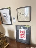 Overall view showing wall clock and two framed prints
