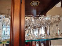 Shelf view showing multiple crystal wine glasses with different bowl shapes