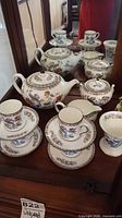 overall view of Wedgwood Kutani Crane tea service showing teapot, sugar bowl, creamer, cups, saucers and waste bowl
