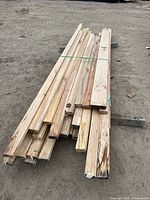 Side view of bundled maple tongue and groove boards on ground