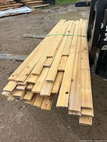 Stack of cedar V-joint boards strapped together on forklift forks