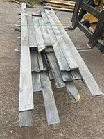 Stack of grey rough-sawn pine boards on forks