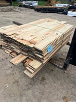 Stacked bundle of V-joint pine boards banded together