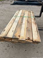 Top view of bundled weathered boards strapped together