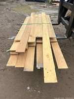 Top view of strapped 1×6 lumber boards on forklift tines