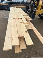 Stack of planed 1x6 V-joint pine boards on forklift