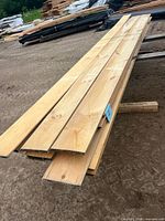 Stack of white pine shiplap boards viewed from top/side