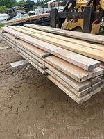 Side view of stacked pine boards showing thickness and banding