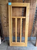 Front view of cedar screen door frame showing overall design and condition