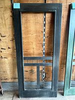 Front view of charcoal-finished cedar screen door frame
