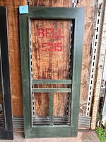 Front view of green painted cedar screen door frame