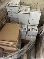 Pallet with multiple sealed white and brown boxes of Ultrasave Q-Kit LED conversion kits