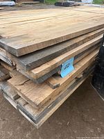 Stacked bundle of rough maple boards side view