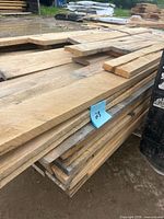 side view of stacked rough maple boards
