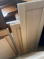 Group of assorted oak and maple cabinet doors showing varying sizes and styles