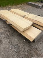 Stack of planed poplar slabs showing live edges and smooth faces