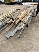 Stack of mixed poplar and oak boards on trailer, showing varied widths and end-seal colors