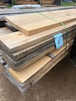 stacked rough maple boards strapped together