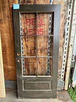 Full front view of oak door showing glass panes and panel