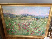 Framed oil painting showing landscape with flowers, hills, and mountains, signed l.l.