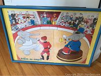 Babar Au Cirque print in blue wooden frame with yellow matting showing circus elephants performing.