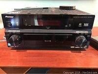 Front view of the Pioneer Elite VSX-82TXSS multichannel receiver showing digital display and control knobs.