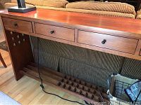 Full front view showing three drawers and lower grid shelf