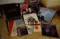 Photo showing a selection of vinyl records including Madness, Devo, Joe Jackson, Black Uhuru, and soundtracks for Blade Runner and Times Square, plus some concert programs.