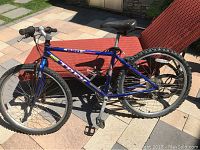 Side view of blue Trek 820 mountain bike showing frame, wheels, tires, and saddle.