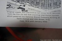 Photo of a card describing the copper bolt and bronze nut with historical context and origin from the National Biscuit Company building.